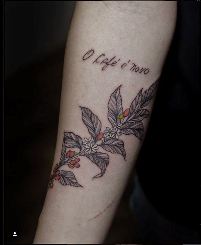 Floral tattoo made in fineline, sketch style, on the inner forearm, representing a coffee branch with the addition of a ticket signature.