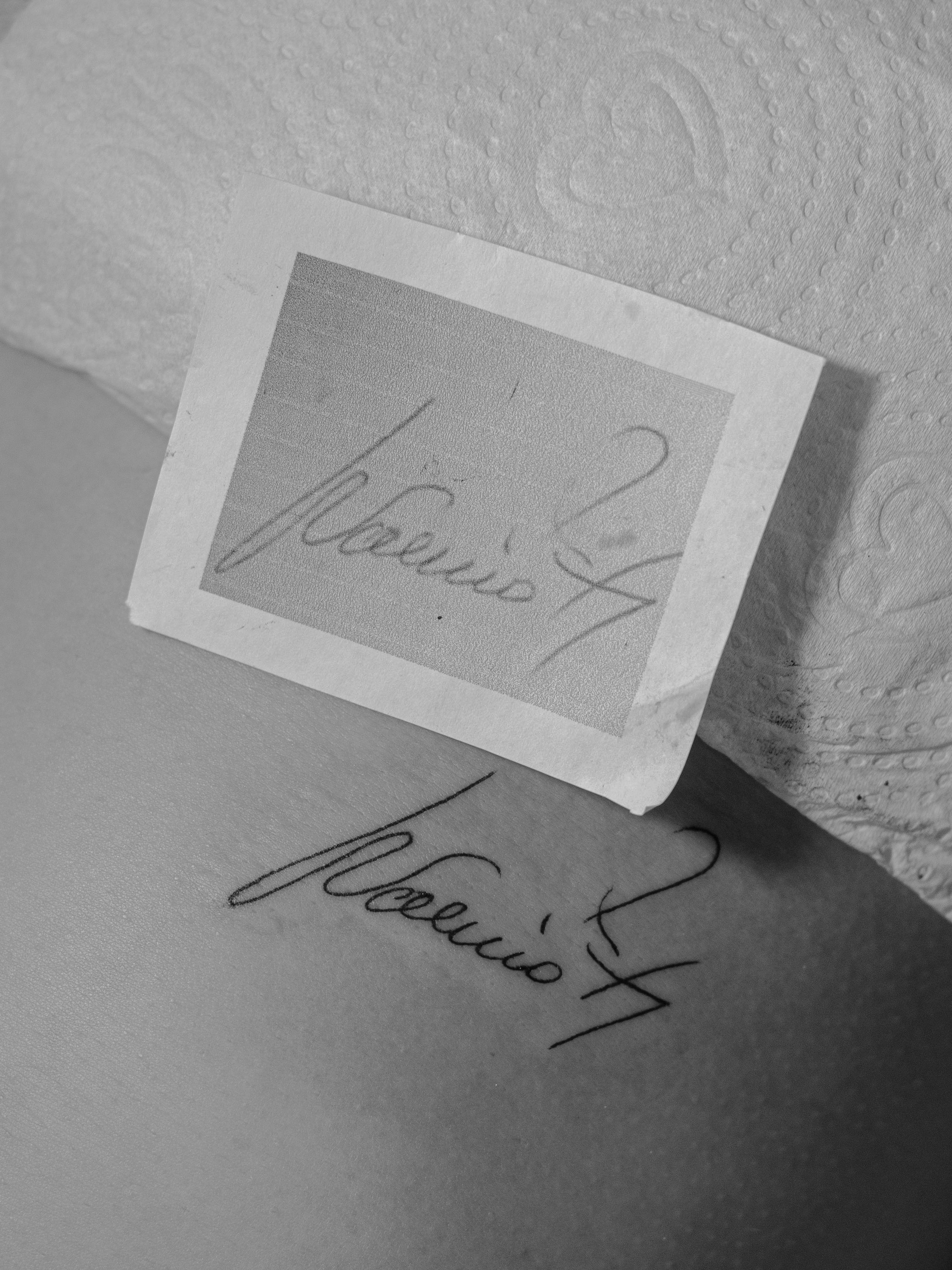 Minimalist tattoo made in fineline on the rib area, with the client's grandfather's own signature.