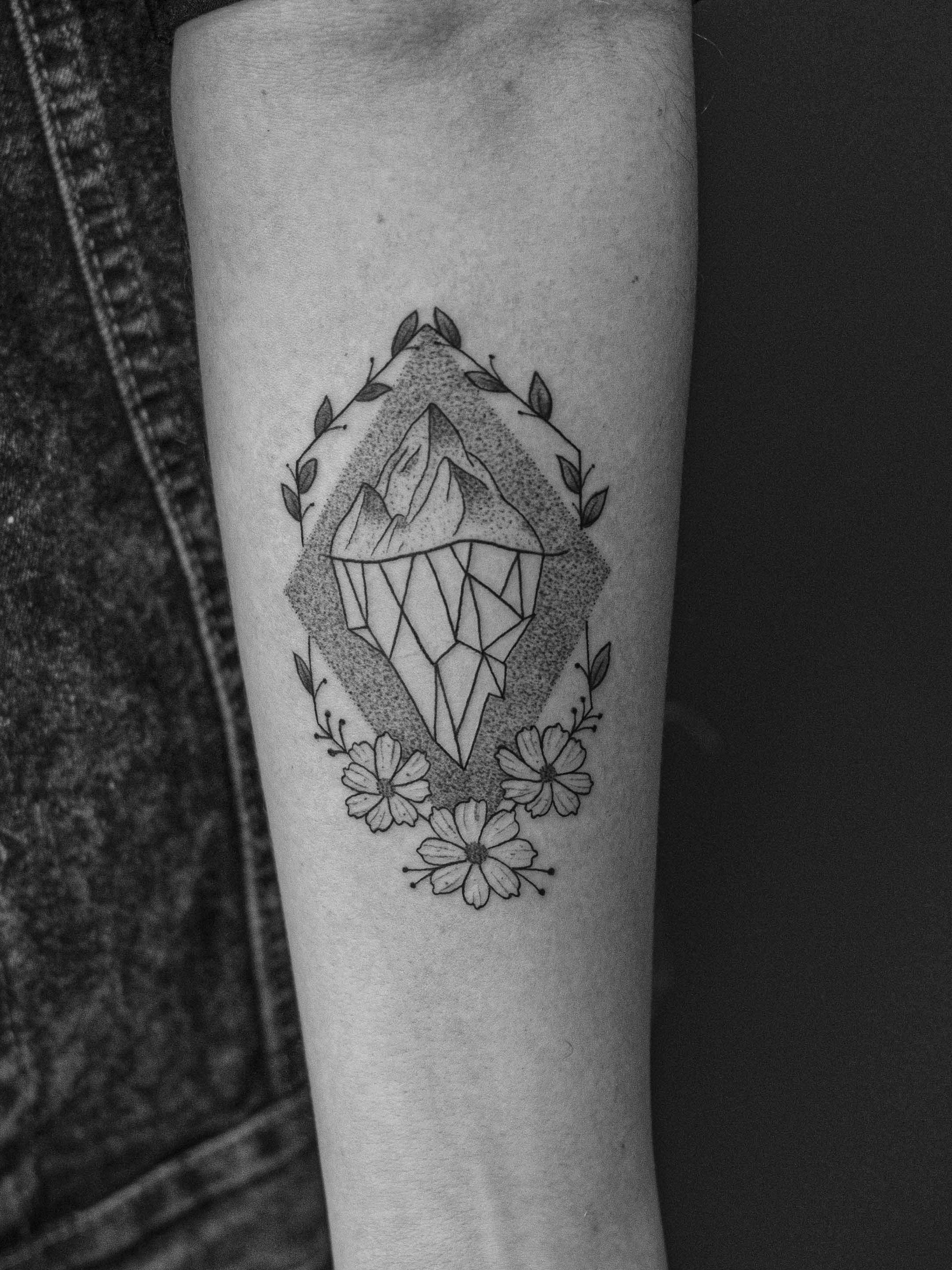 Minimalist tattoo made in dotwork on the forearm area, representing an iceberg, bringing the symbolism of the conscious and unconscious mind.