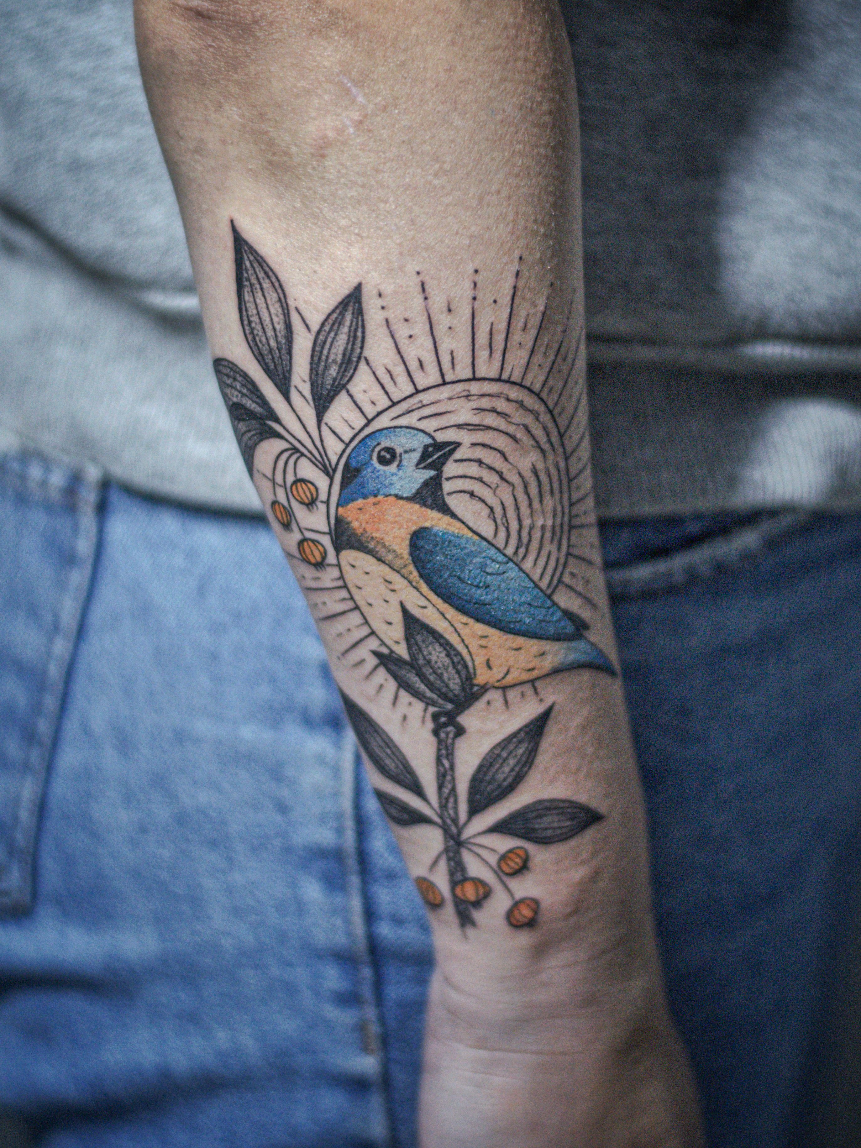 Minimalist tattoo made in fineline, colored, sketch style, representing a bird on a pitanga branch with the sun in the background.
