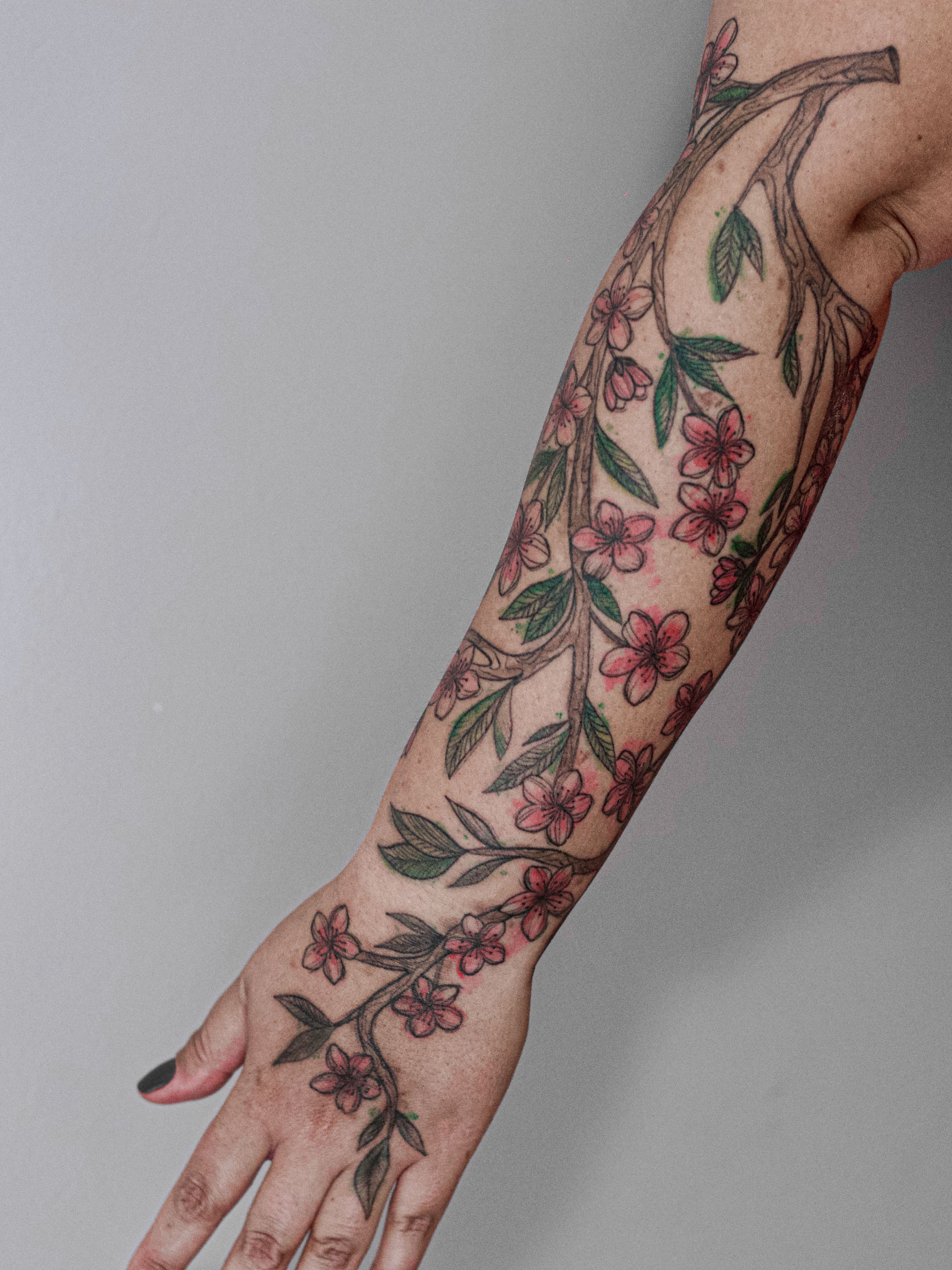 Tattoo made in fineline, colored watercolor style, sketch style, representing a pitanga branch.